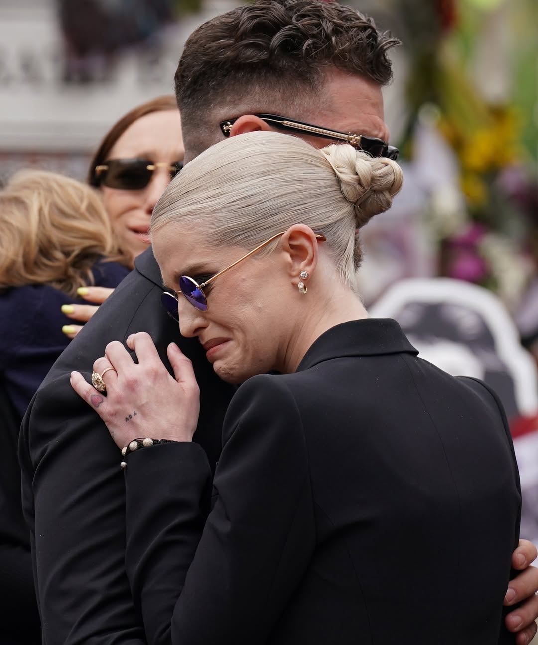 sharon-osbourne-is-comforted-by-her-children-jack-and-kelly-as-she-leads-ozzy-osbournes-funeral-2-1753944656.jpg