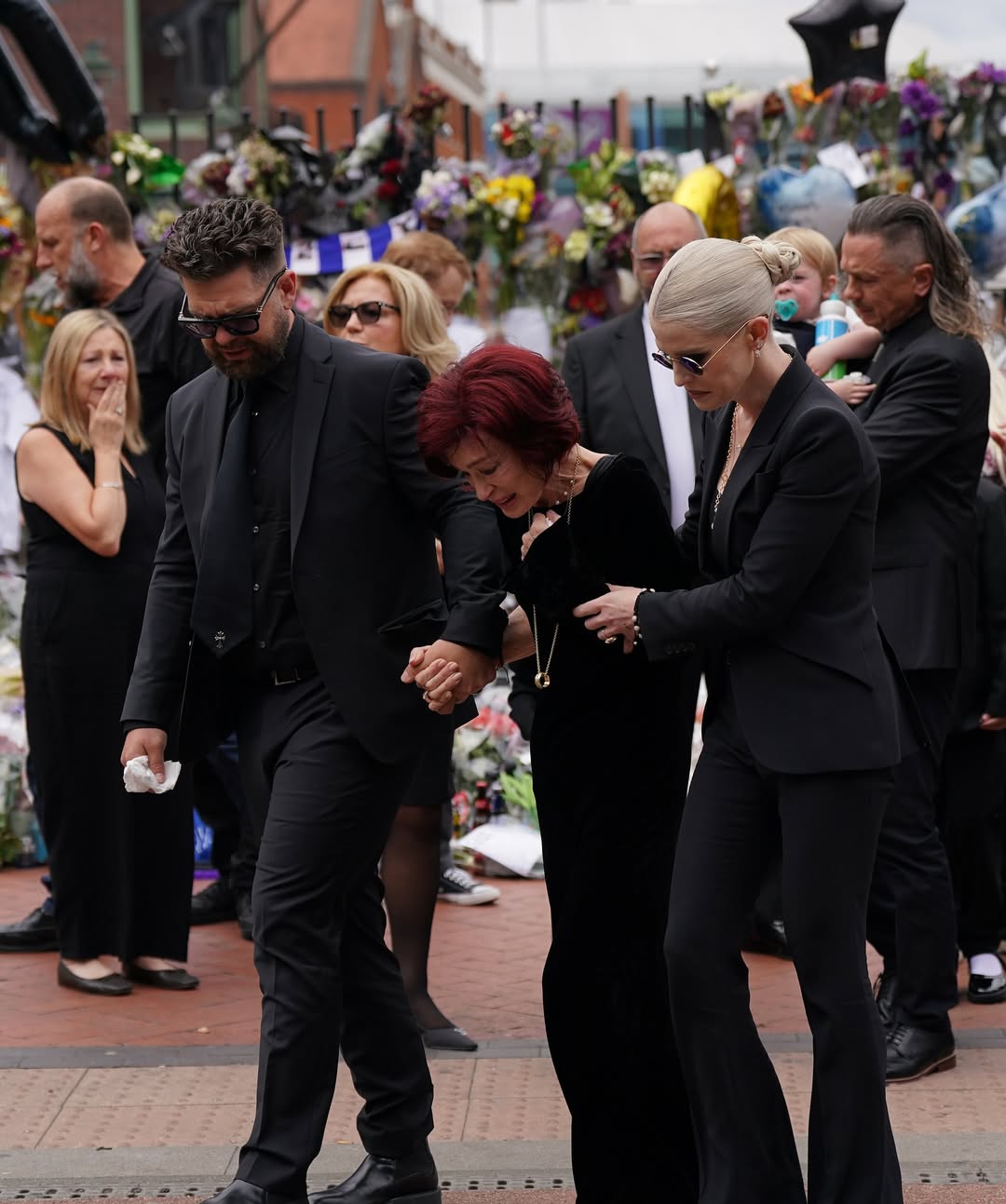sharon-osbourne-is-comforted-by-her-children-jack-and-kelly-as-she-leads-ozzy-osbournes-funeral-3-1753944656.jpg