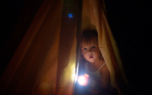 the-girl-under-a-cover-holds-at-dark-night-a-small-lamp-in-hand-picture-id932572260-1761639203.jpg